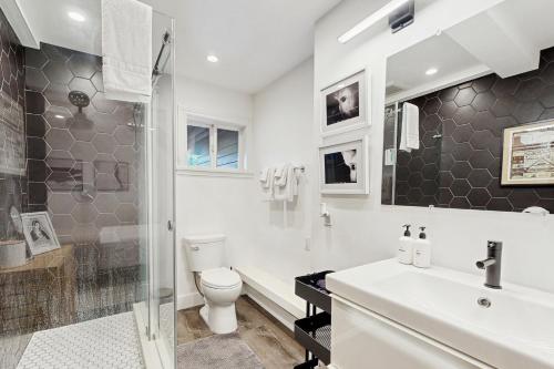 a bathroom with a sink and a toilet and a shower at Rio Lindo River Retreat in Healdsburg