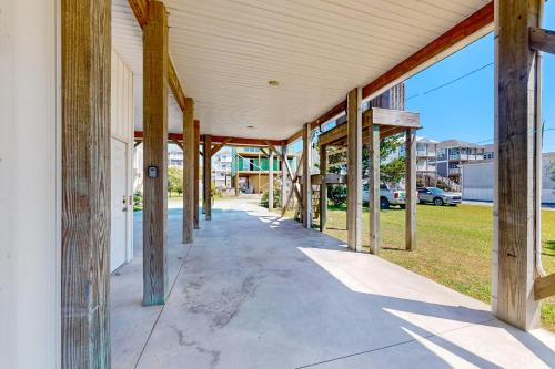 a building being constructed with wooden beams on a sidewalk at Turtle Cove in North Topsail Beach