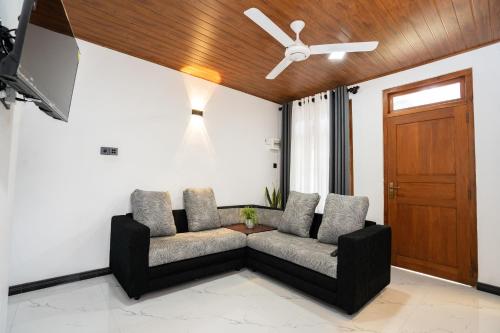 a living room with a couch and a ceiling fan at Velora Ridge in Kundasale
