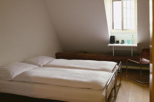 a bedroom with two beds and a window at Hotel St Petersinsel in Sankt Petersinsel