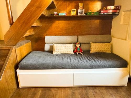 a small bed with a teddy bear sitting on it at Happy Place in Rethymno Town