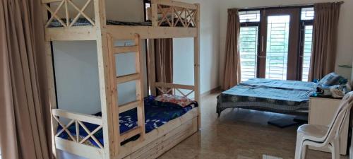 a bedroom with two bunk beds and a bed at View Point Stay in Yelagiri
