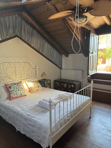 a bedroom with a white bed with a wooden ceiling at Happy Place in Rethymno