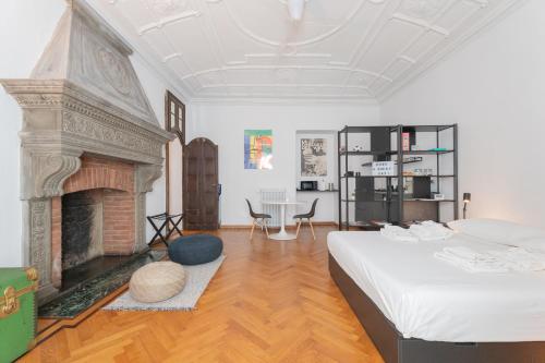 a bedroom with a bed and a fireplace at Appartamenti boutique "Camerana14" in Turin