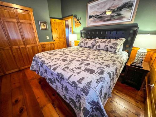 a bedroom with a bed with a blue and white comforter at An Appalachian Hideaway in Brownwood