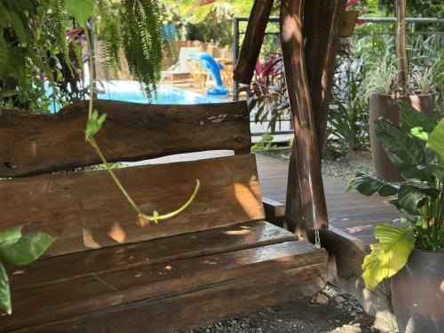 a wooden bench sitting in front of a pool at Hotel Borari in Alter do Chao