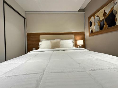 a bedroom with a large white bed in it at ABIBA Apart-Hotel & SPA in Asuncion