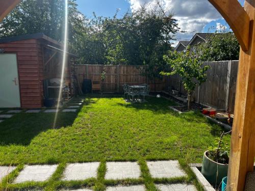 a backyard with a yard with a fence at Cherry Hill Studio in Caversham