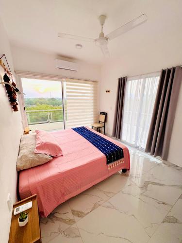 a bedroom with a bed and a large window at Almare F4 in Puerto Escondido