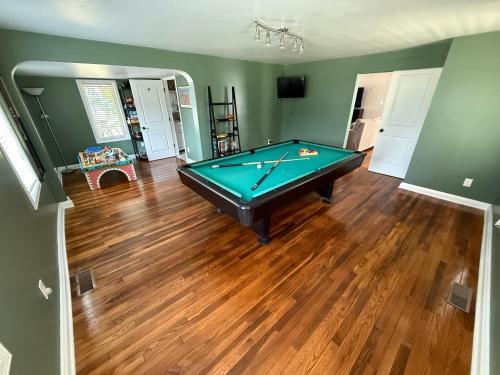 a living room with a pool table in it at Wine Down in Hammondsport