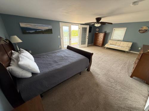 a bedroom with a bed and a ceiling fan at Wine Down in Hammondsport