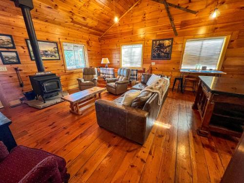 a living room with a couch and a stove at An Appalachian Hideaway in Brownwood