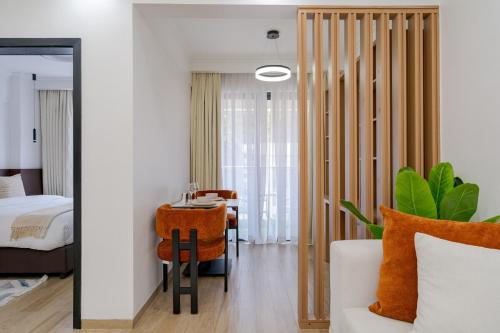 a bedroom with a bed and a table and a chair at Casa Inikas -Luxurious 1 bedroom Marina Bay in Nairobi
