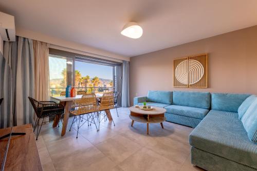a living room with a blue couch and a table at Azure Sofia - Maisonette in Lampi