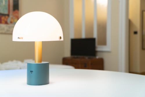a lamp sitting on top of a white table at Appartamenti boutique "Camerana14" in Turin