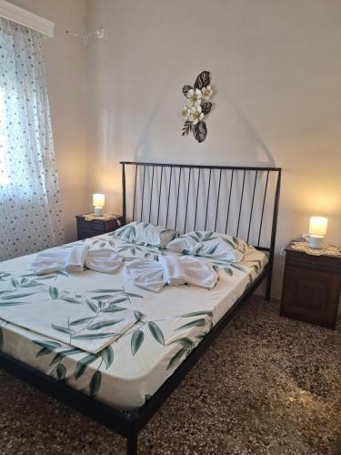 a bed in a bedroom with a butterfly on the wall at Eva's house in Xanthi