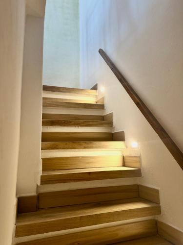 a staircase with wooden steps in a house at Sogni sul Lago - Passignano sul Trasimeno in Passignano sul Trasimeno