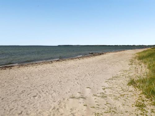 a sandy beach with the ocean in the background at Holiday Home Pellervo - 20m from the sea by Interhome in Assens