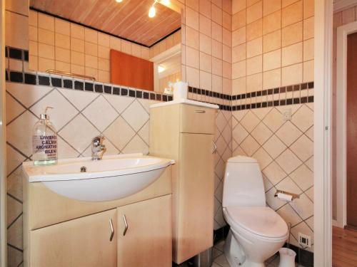 a bathroom with a sink and a toilet at Holiday Home Arton - 300m from the sea by Interhome in Ebberup