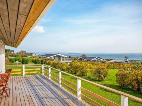 a wooden deck with a view of the ocean at Holiday Home Arton - 300m from the sea by Interhome in Ebberup