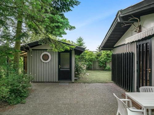 a patio with a table and chairs in front of a house at Holiday Home Juditha - 400m from the sea by Interhome in Middelfart