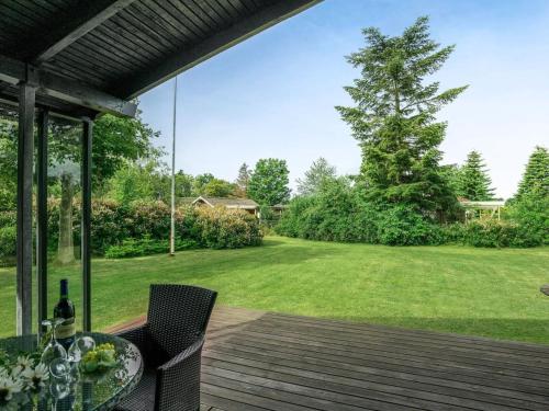 a patio with a table and chairs on a deck at Holiday Home Juditha - 400m from the sea by Interhome in Middelfart