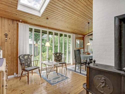 a living room with a table and chairs and a window at Holiday Home Juditha - 400m from the sea by Interhome in Middelfart