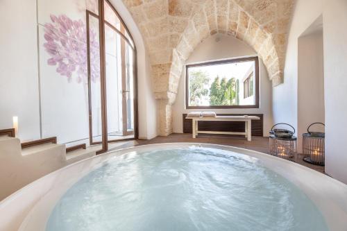 a large pool of water in a room with windows at Villa Perla del Mare in Carovigno