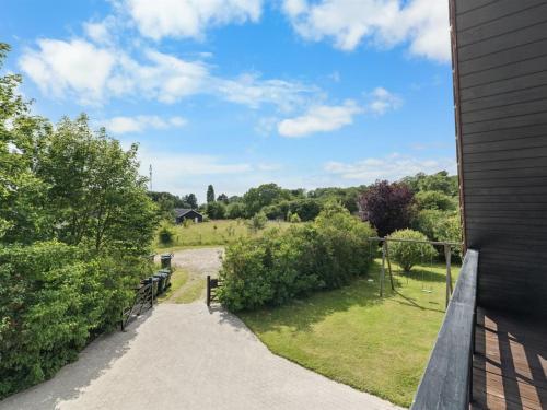 a walkway leading to a field with a house at Holiday Home Jorith - 550m from the sea by Interhome in Tranekær