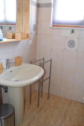 a bathroom with a white sink in a room at Villa STEFY in Fragneto Monforte