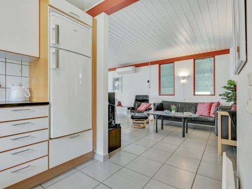 a kitchen and living room with a couch and a table at Holiday Home Emly - 1-1km from the sea by Interhome in Humble