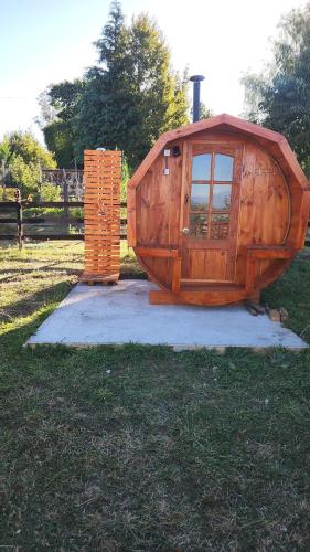 a large wooden house sitting in the grass at Centro Turístico Epu Pillan Domo in Panguipulli