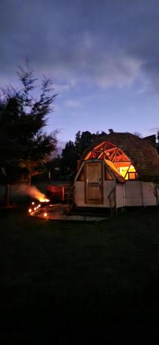 a large tent is lit up at night at Centro Turístico Epu Pillan Domo in Panguipulli