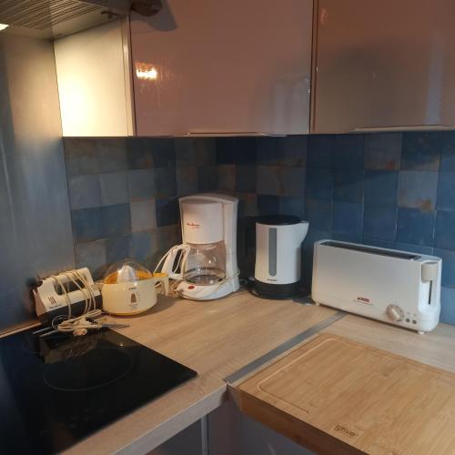 a kitchen counter with various appliances on it at Maison de campagne 