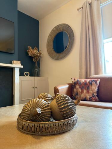a bowl of baskets on a table in a living room at The Whitchurch Apartment- The Painted Rooms in Whitchurch