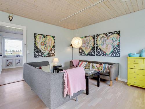 a living room with a couch and a table at Holiday Home Ewelina - 15km from the sea by Interhome in Ballum