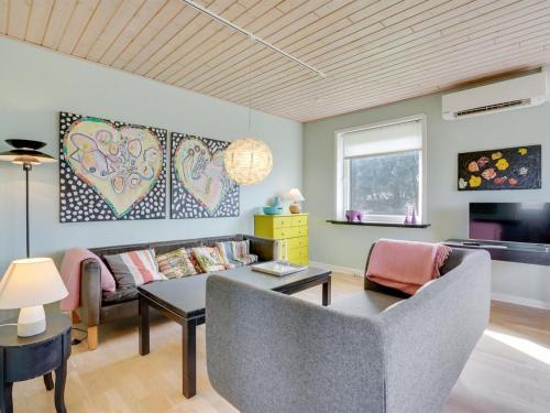 a living room with a couch and a table at Holiday Home Ewelina - 15km from the sea by Interhome in Ballum
