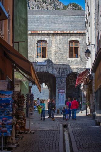 a group of people walking through an archway in a building at Maison à Tour Briançon in Briançon