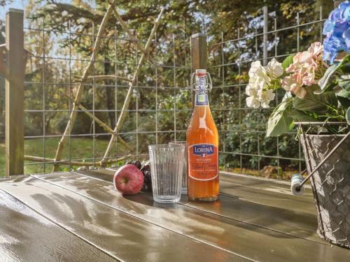 a bottle of beer and a glass on a table at Holiday Home Elisabeta - 28km from the sea by Interhome in Toftlund