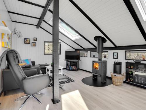 a living room with a couch and a fireplace at Holiday Home Elisabeta - 28km from the sea by Interhome in Toftlund