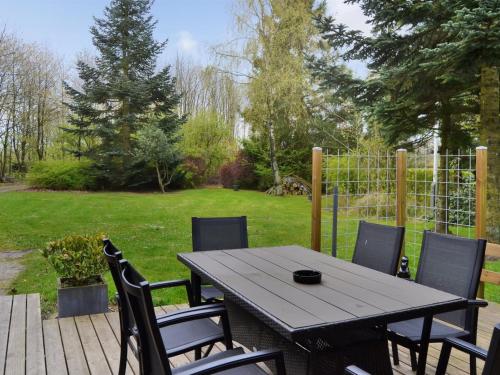 a table and chairs on a patio with a yard at Holiday Home Elisabeta - 28km from the sea by Interhome in Toftlund