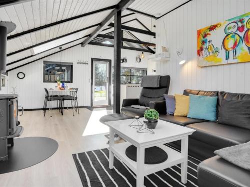 a living room with a couch and a table at Holiday Home Elisabeta - 28km from the sea by Interhome in Toftlund