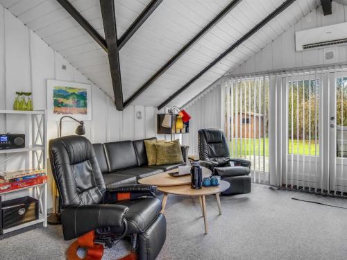 a living room with a couch and two chairs at Holiday Home Liljana - 30km from the sea by Interhome in Toftlund