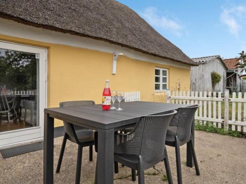 a black table with chairs and a ketchup bottle on it at Holiday Home Miko - 19km from the sea by Interhome in Skærbæk