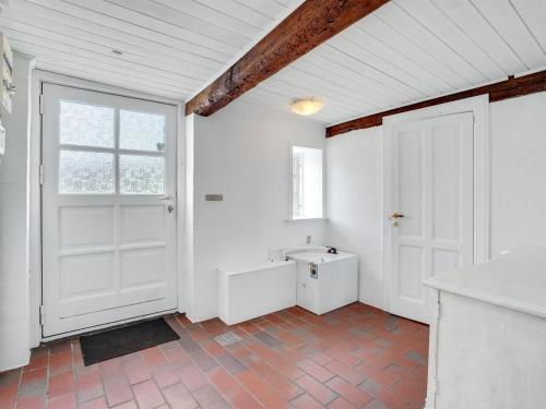 a white room with a white door and a window at Holiday Home Miko - 19km from the sea by Interhome in Skærbæk