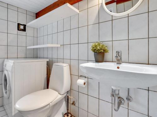 a bathroom with a toilet and a sink at Holiday Home Miko - 19km from the sea by Interhome in Skærbæk