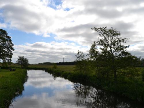 a river with trees and clouds in the sky at Holiday Home Josina - 32km from the sea by Interhome in Esbjerg