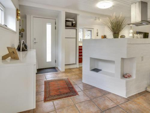 a kitchen with a fireplace in the middle of a room at Holiday Home Josina - 32km from the sea by Interhome in Esbjerg