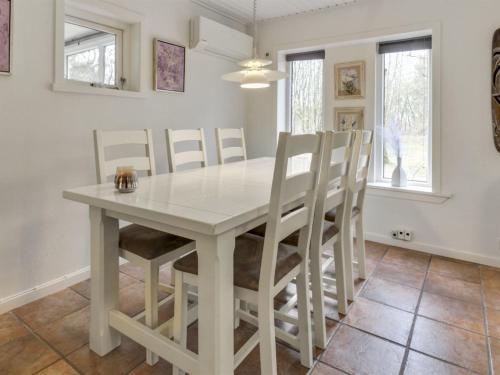a dining room with a white table and chairs at Holiday Home Josina - 32km from the sea by Interhome in Esbjerg