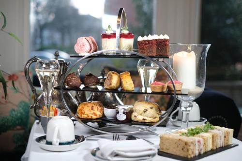 a tray of pastries and desserts on a table at Brockley Hall Hotel in Saltburn-by-the-Sea